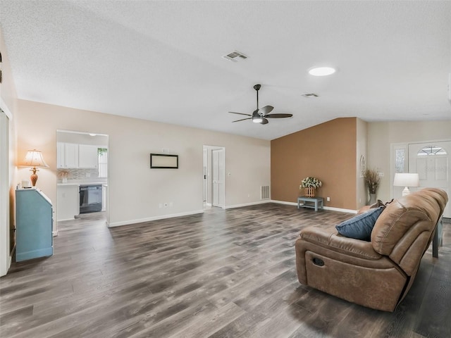 living area with lofted ceiling, visible vents, a ceiling fan, and wood finished floors