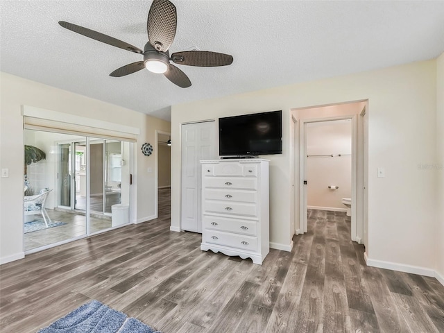 unfurnished bedroom with a textured ceiling, baseboards, ceiling fan, and wood finished floors