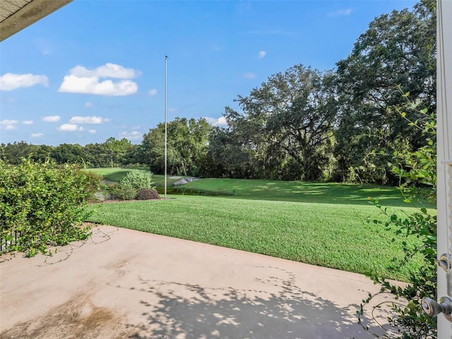 view of community featuring a yard and a patio