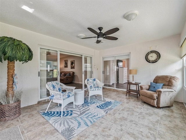 interior space featuring a ceiling fan and a textured ceiling