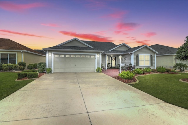 view of front of property with a lawn and a garage