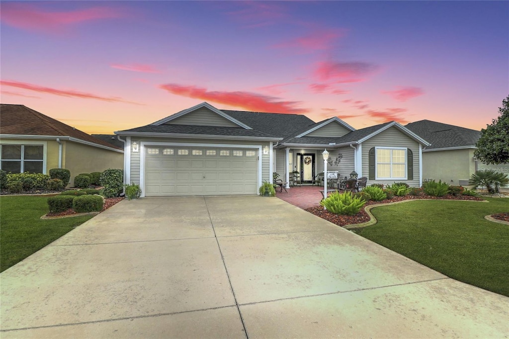 view of front of home featuring a garage and a yard