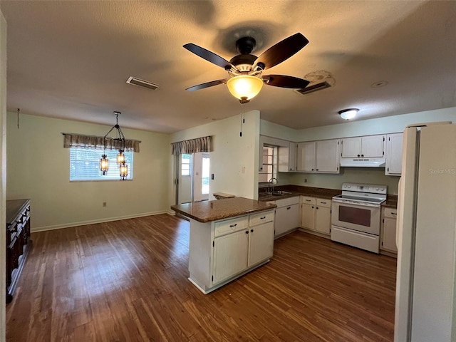 kitchen with dark hardwood / wood-style floors, ceiling fan, kitchen peninsula, decorative light fixtures, and white appliances