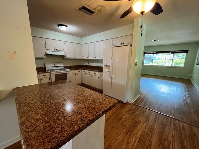 kitchen featuring dark hardwood / wood-style flooring, white appliances, ceiling fan, white cabinetry, and kitchen peninsula