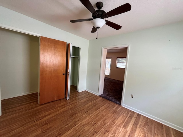 unfurnished bedroom with hardwood / wood-style floors and ceiling fan