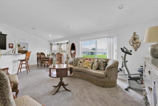 living room featuring light carpet and vaulted ceiling