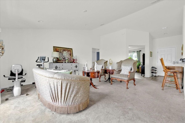 carpeted living room featuring vaulted ceiling