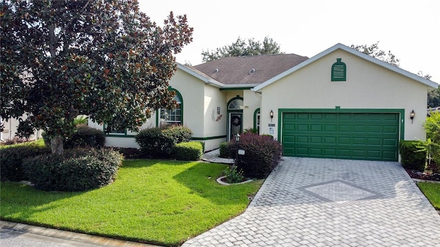 single story home featuring a garage and a front yard