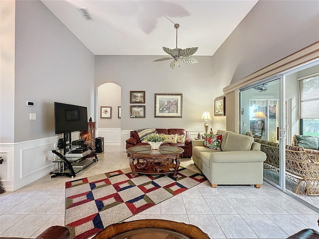 living room with light tile patterned flooring and high vaulted ceiling