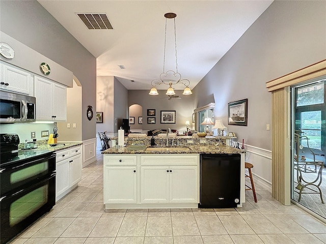 kitchen featuring black appliances, dark stone countertops, sink, and white cabinetry