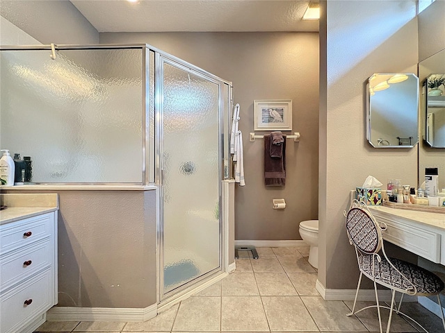 bathroom featuring toilet, tile patterned floors, vanity, and an enclosed shower