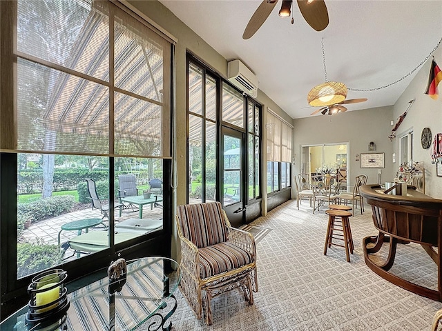 sunroom featuring a wall unit AC and ceiling fan