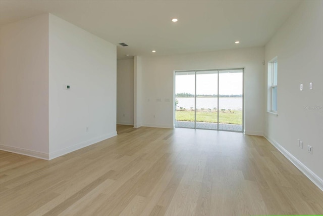 spare room featuring light hardwood / wood-style floors