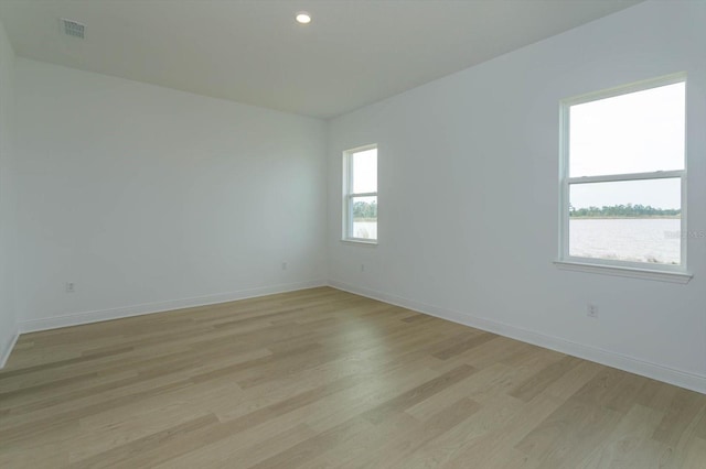 spare room featuring light hardwood / wood-style flooring