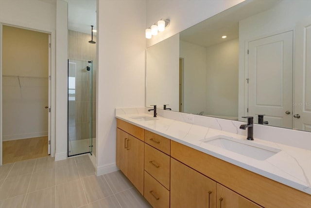 bathroom featuring vanity, tile patterned flooring, and walk in shower