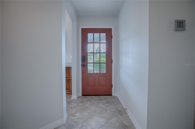 doorway with light tile patterned flooring