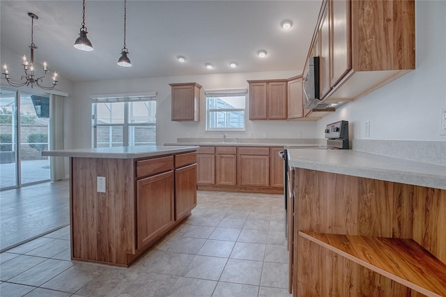 kitchen with a center island, stainless steel appliances, an inviting chandelier, decorative light fixtures, and lofted ceiling