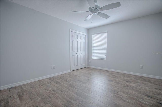 empty room featuring light hardwood / wood-style floors and ceiling fan