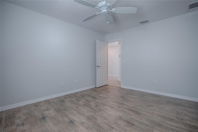 unfurnished room with ceiling fan and light wood-type flooring