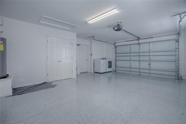 garage featuring a garage door opener and washing machine and clothes dryer