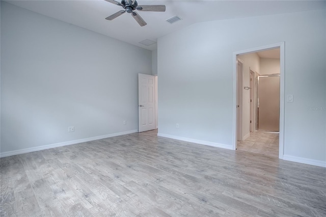 spare room featuring ceiling fan, vaulted ceiling, and light wood-type flooring