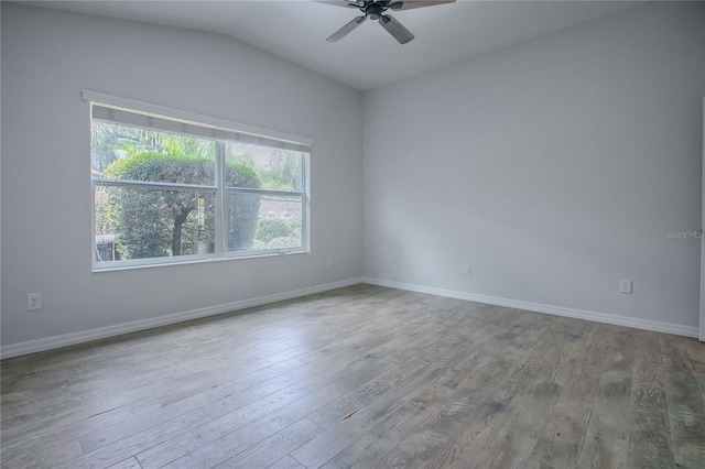 unfurnished room with hardwood / wood-style flooring, ceiling fan, and vaulted ceiling