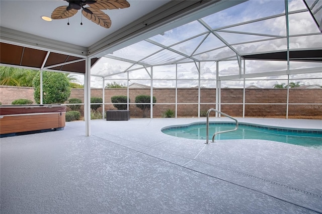 view of pool featuring ceiling fan, a patio area, a lanai, and a hot tub