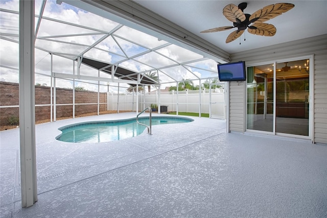 view of pool with a lanai, a patio area, and ceiling fan