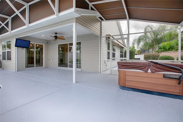 view of patio with ceiling fan and a hot tub