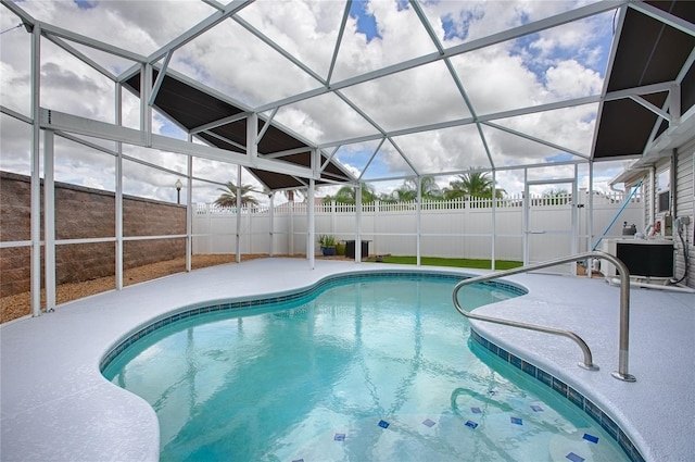 view of swimming pool featuring a patio and glass enclosure