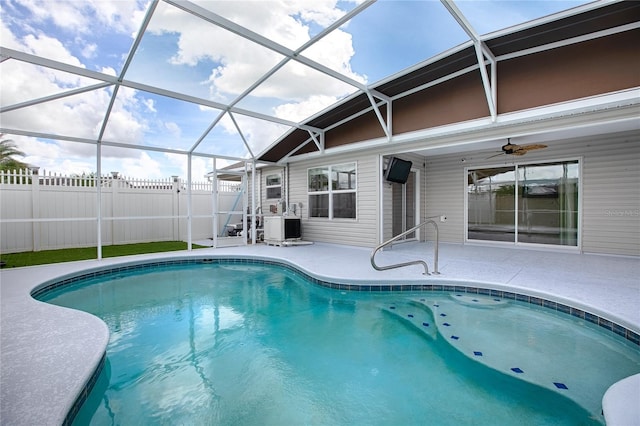 view of pool featuring ceiling fan, a lanai, and a patio