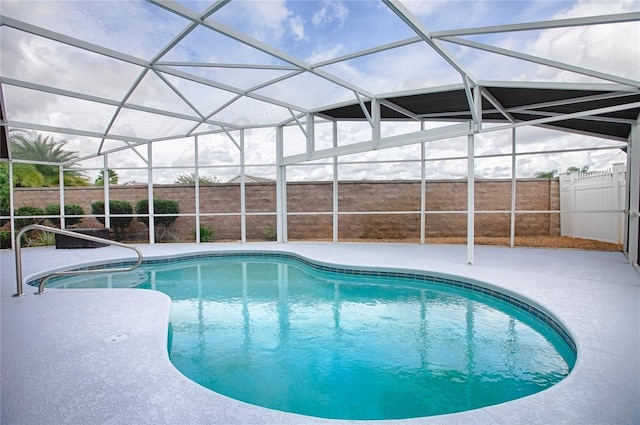 view of swimming pool featuring a lanai and a patio area