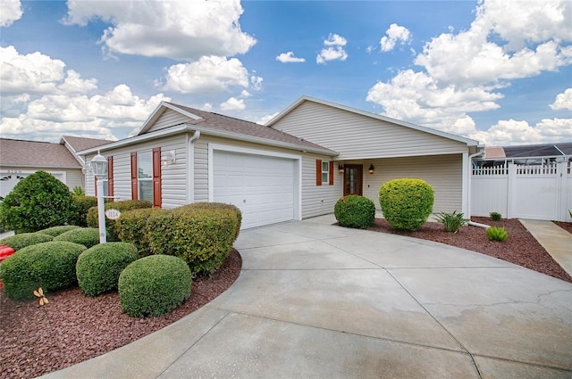 ranch-style home with a garage, driveway, fence, and a gate