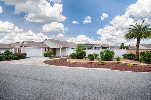 ranch-style home featuring a residential view, an attached garage, driveway, and fence