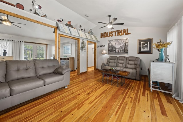 living room with hardwood / wood-style flooring, vaulted ceiling, ceiling fan, and french doors