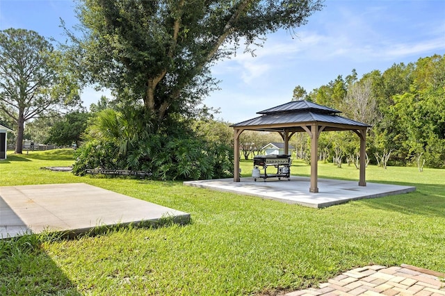 view of community with a gazebo, a yard, and a patio area