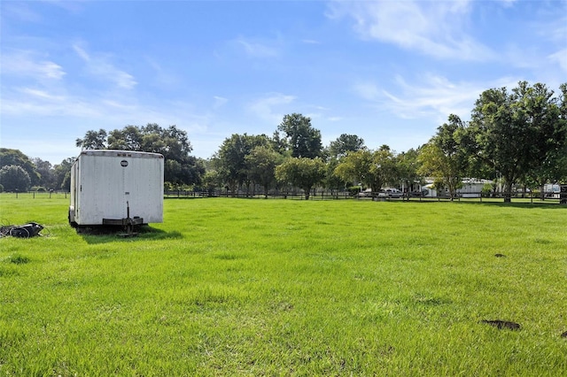 view of yard featuring a shed and a rural view