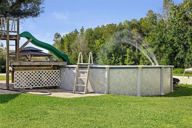 exterior space with a playground, a gazebo, and a yard