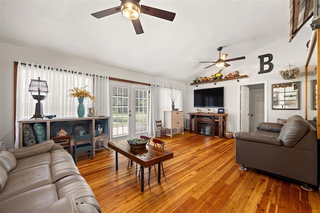 living room with french doors, ceiling fan, vaulted ceiling, and hardwood / wood-style flooring