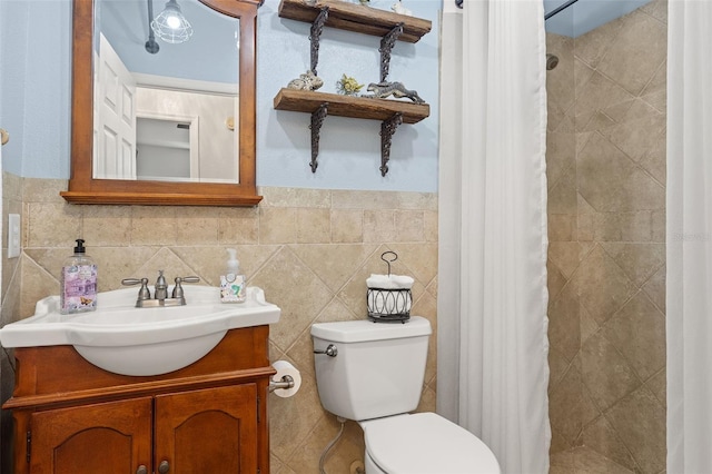 bathroom featuring vanity, toilet, a shower with shower curtain, and tile walls