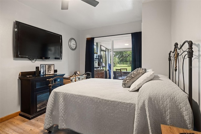 bedroom featuring ceiling fan, access to exterior, and light hardwood / wood-style flooring