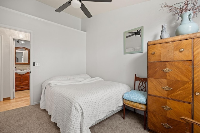 bedroom with sink, carpet floors, ceiling fan, and ensuite bathroom