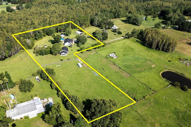 birds eye view of property with a rural view