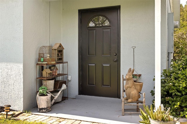 property entrance with stucco siding