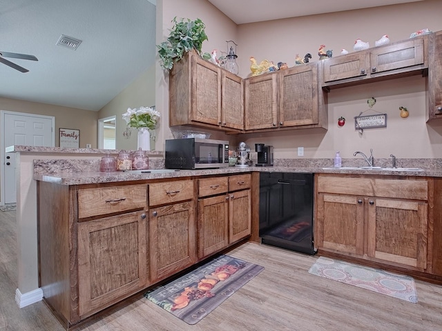 kitchen with ceiling fan, light wood-type flooring, lofted ceiling, and kitchen peninsula