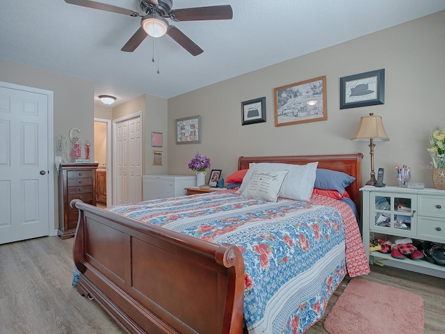 bedroom with light wood-type flooring, a closet, and ceiling fan