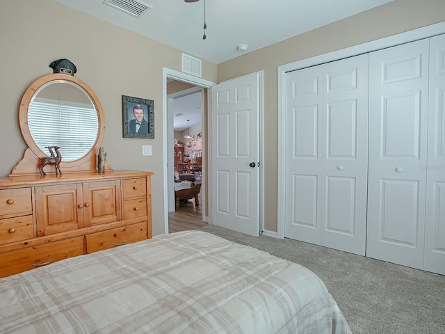 bedroom with a closet and light colored carpet