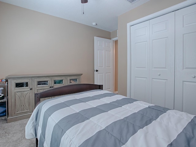 bedroom with light colored carpet and a closet