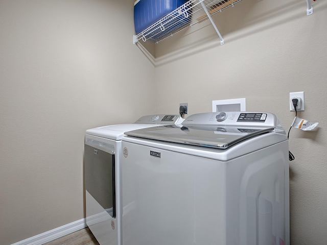 laundry area with independent washer and dryer