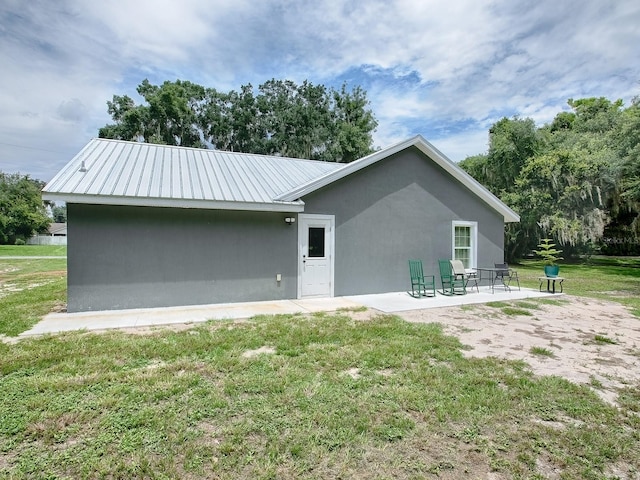 rear view of property with a patio area and a yard